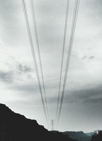 Low angle view of electricity pylon against sky