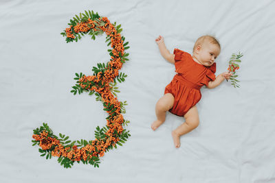 High angle view of cute girl lying on plant