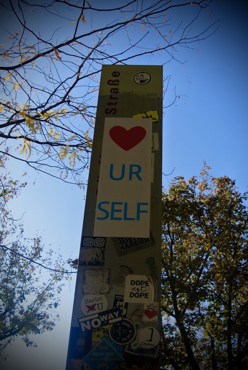 LOW ANGLE VIEW OF SIGN BOARD AGAINST SKY