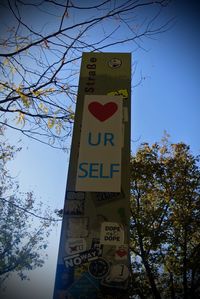 Low angle view of road sign against sky