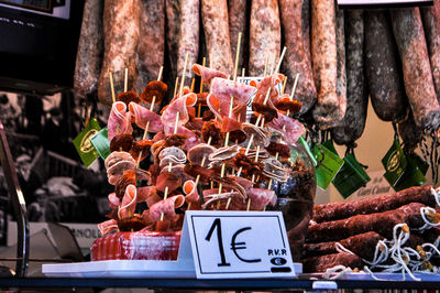 Close-up of meat in skewer with label at market stall