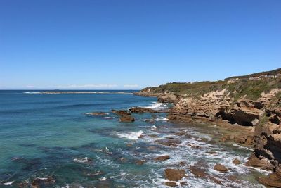 Scenic view of sea against clear blue sky