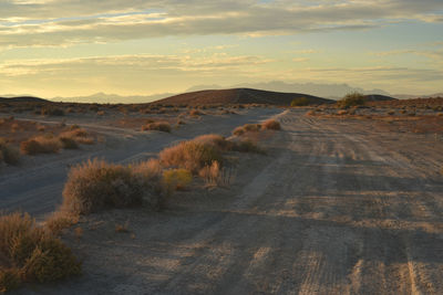 Road amidst landscape against sky during sunset