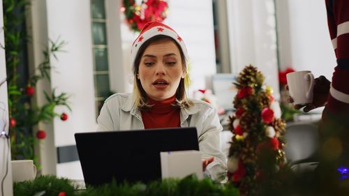 Portrait of young woman using laptop at home