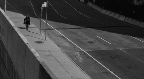 High angle view of woman walking on footpath