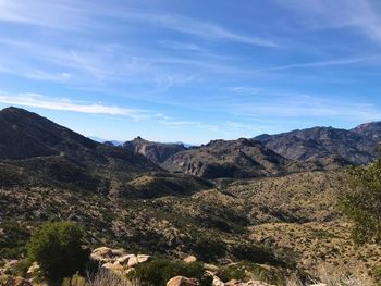 Scenic view of mountains against blue sky