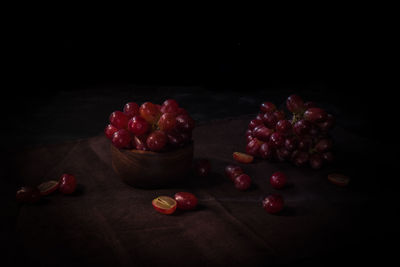 Close-up of strawberries on table against black background