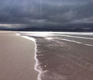 Scenic view of sea against storm clouds