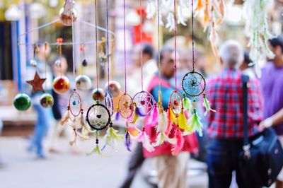 Close-up of multi colored dreamcatcher hanging outdoors