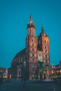 Illuminated building against blue sky at dusk