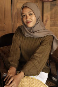 Portrait of a young woman sitting outdoors