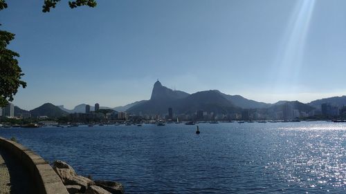 Calm sea with mountain range in background