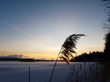 Scenic view of lake against sky at sunset