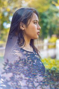 Side view of young woman looking away