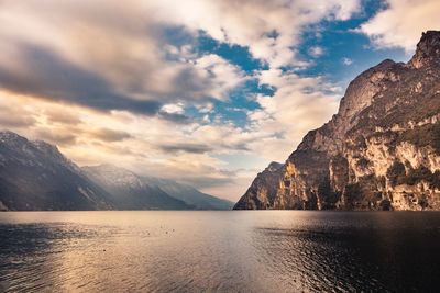 Scenic view of sea and mountains against sky