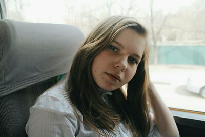 Portrait of young woman sitting in bus