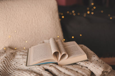 Low section of woman reading book