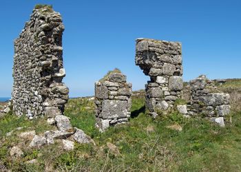 Old ruins on field against clear sky