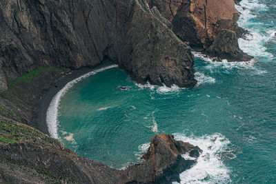 High angle view of rocks on sea shore