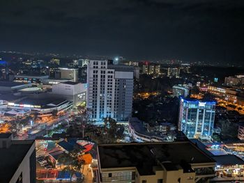 High angle view of illuminated buildings in city at night