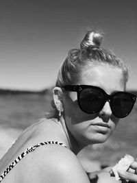 Portrait of woman wearing sunglasses against sky