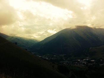 Scenic view of mountains against cloudy sky