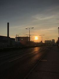 Street against sky during sunset in city