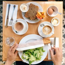 High cropped image of person having breakfast at table