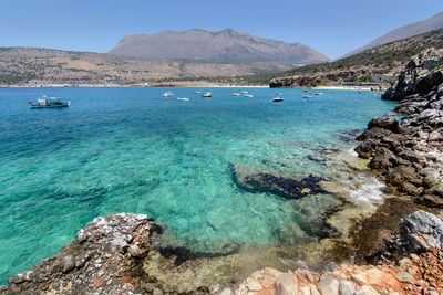 Scenic view of sea against clear blue sky