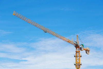 Low angle view of crane against sky