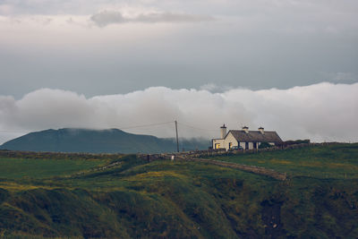 Houses on field against sky