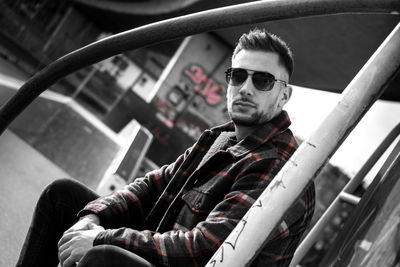 Portrait of young man sitting outdoors