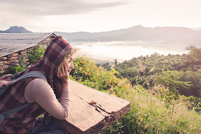 Side view of woman looking at mountains