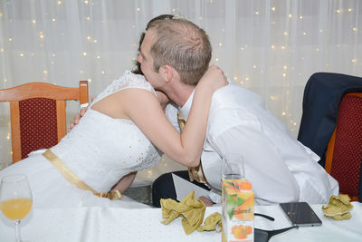 Bride and bridegroom embracing at wedding ceremony