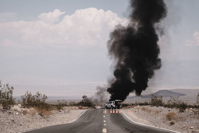 Smoke emitting from car on road