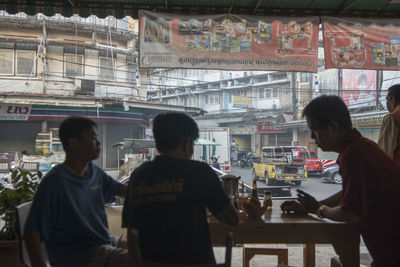 Rear view of people looking at restaurant