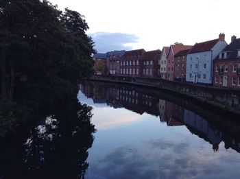 Reflection of buildings and trees in canal