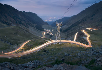 Scenic view of road by mountains against sky