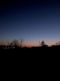 Silhouette landscape against clear sky at sunset