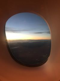 Scenic view of sunset seen through airplane window