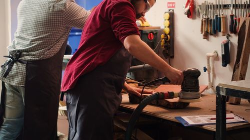 Midsection of man working in workshop