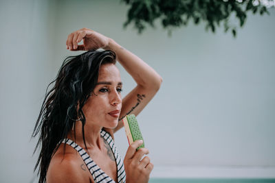 Portrait of woman holding camera