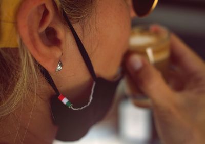 Close-up portrait of a woman drinking coffee 