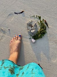 Low section of woman standing on beach