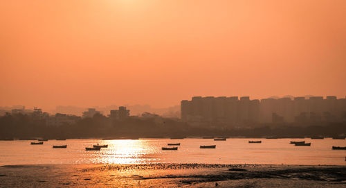 Scenic view of sea against orange sky