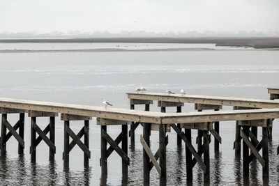 Pier over sea against sky