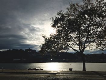 Scenic view of river against sky at sunset