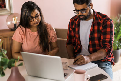 Young woman using laptop at table