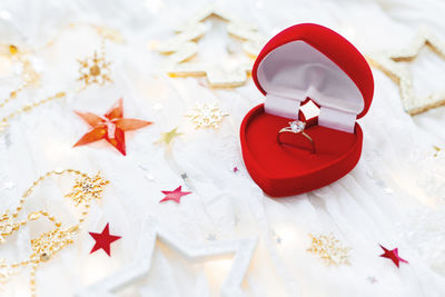 Christmas, new year holiday background with engagement golden ring in heart box. valentine day.