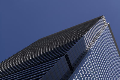 Low angle view of modern building against clear blue sky